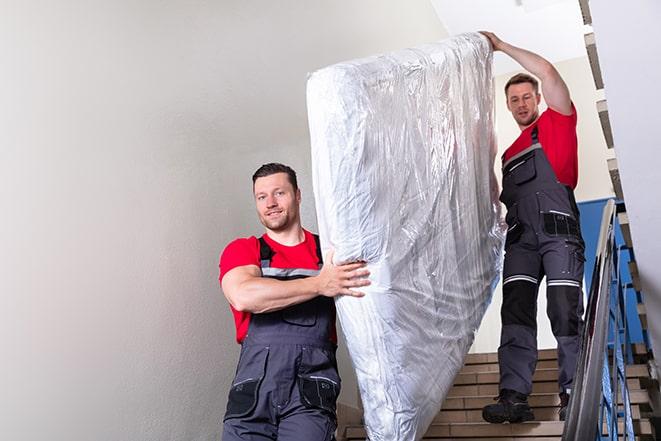 transporting a box spring out of a residential building in Fort Worth, TX